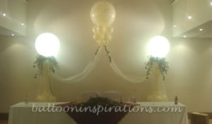 Elegant lit columns display laced with Organza and twinkle lights Lit columns